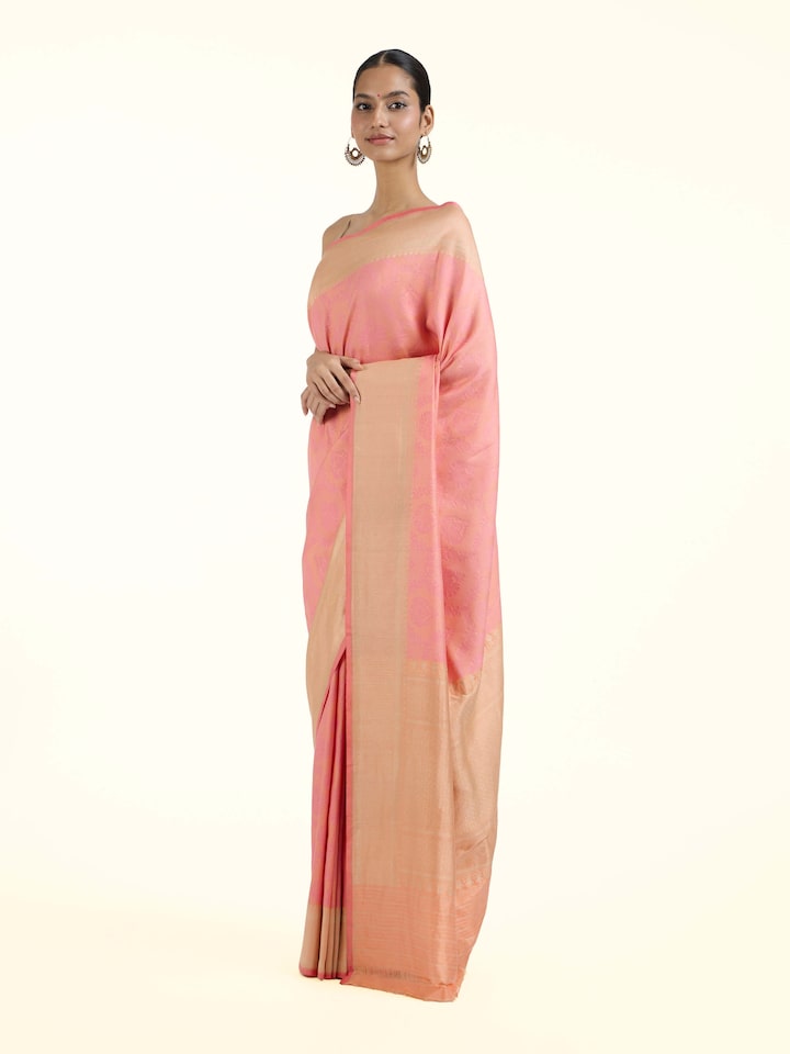 Side view of pink silk Banarasi saree highlighting graceful drape and traditional border
