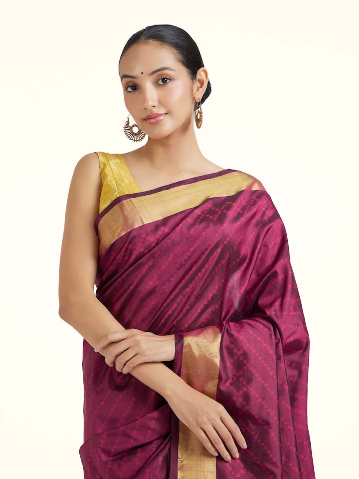Angled view of purple mulberry silk ikat saree highlighting ikat weave and natural sheen