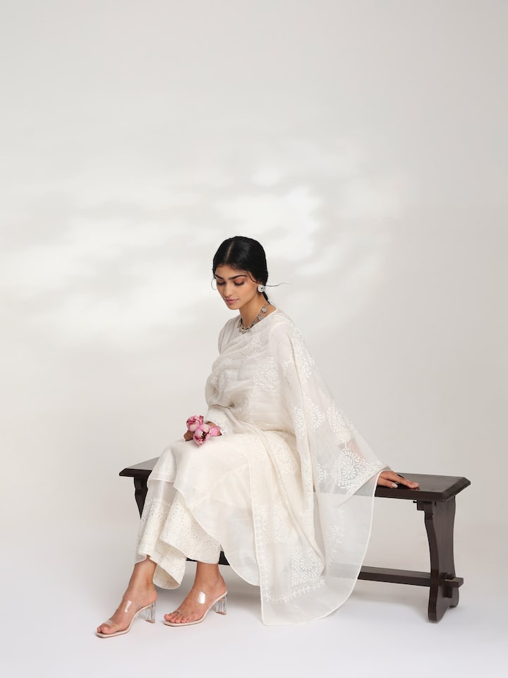 Model showcasing off-white chikankari dupatta in front drape