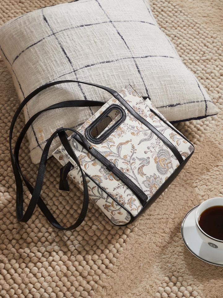 Lifestyle image showing the sling bag styled with an ethnic outfit.