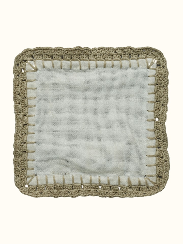 Detail view of Nityam Ivory Cotton Slub Crochet Coasters Set Of 6 highlighting the fabric texture and embroidery detail