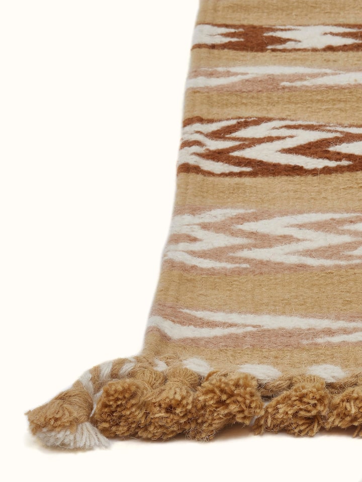 Angle view of Chevron Stripes Yellow Gujarat Wool & Cotton Panja Dhurrie Kharad displaying the chevron pattern.