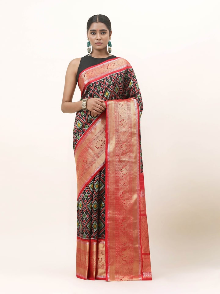 Front view of blue silk Ikat saree featuring bold geometric patterns and sheen.