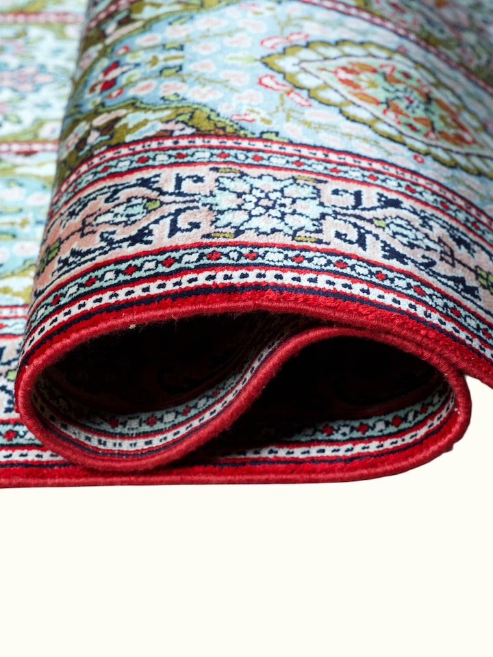 Detailed view of the Traditional Persian Green Gum Kashmir Silk Hand-Knotted Carpet craftsmanship