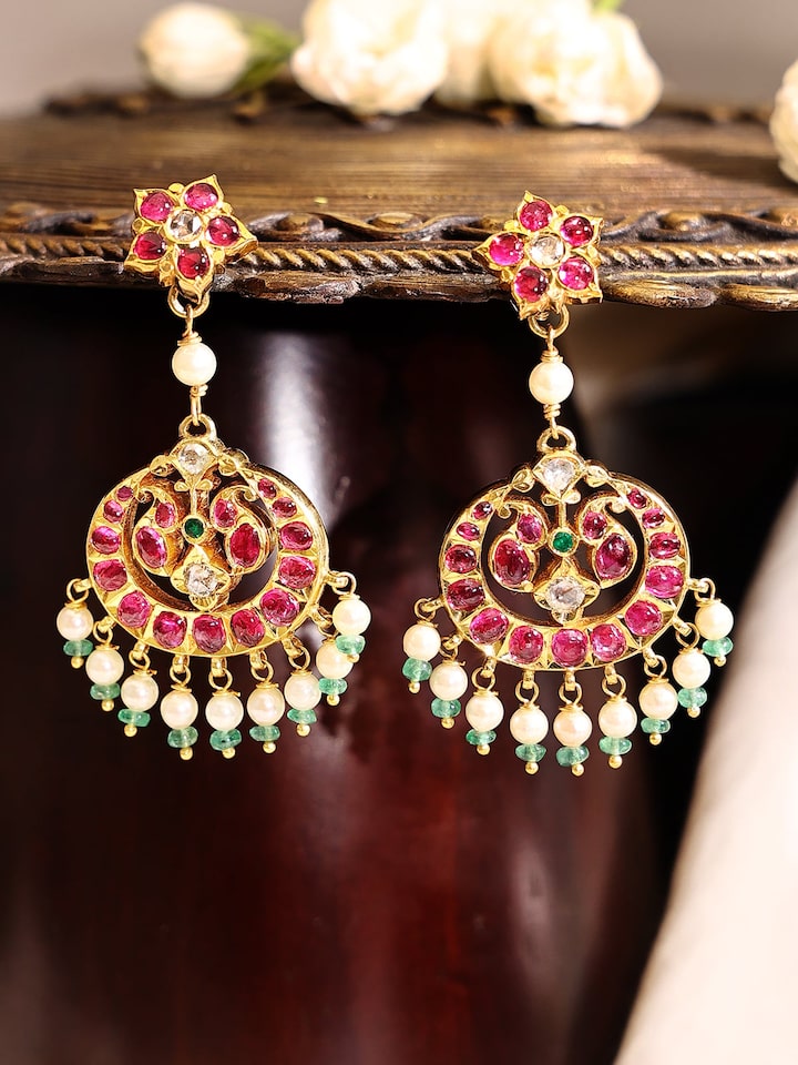 Side view of Kundala Velai 22 karat gold drop earrings highlighting their intricate details