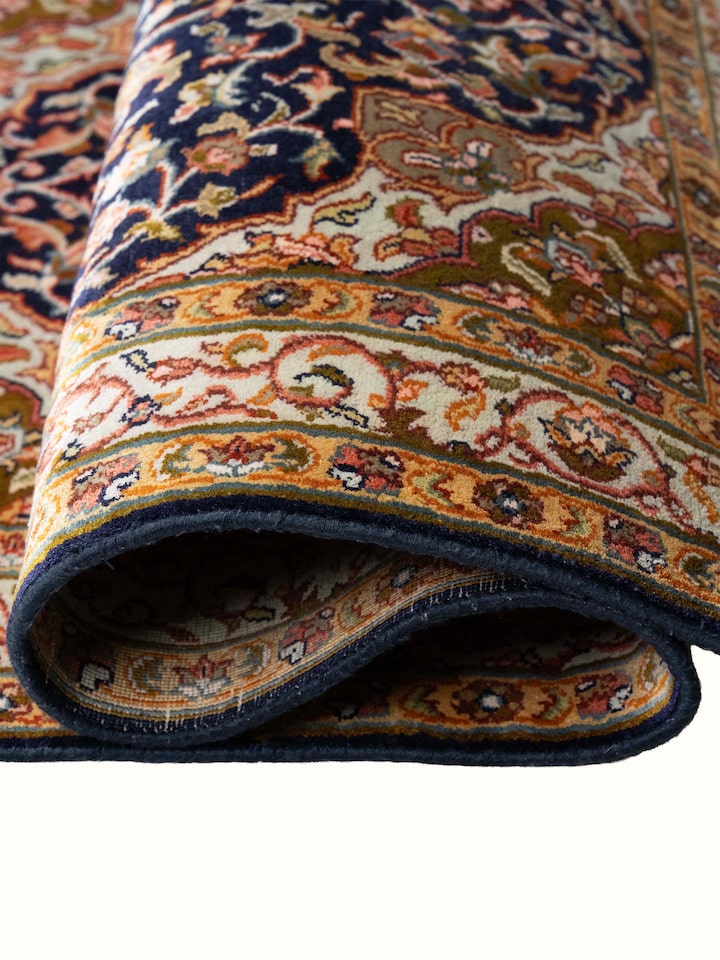 Detail view of Traditional Persian Navy Green Kashan Kashmir Silk Hand-Knotted Carpet highlighting the intricate pattern and pile texture, from a d...