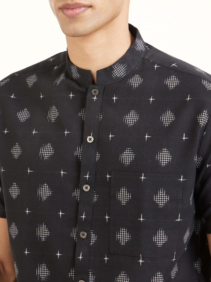 Detail view of black cotton Telangana Ikat shirt showing fine cotton texture and weaving craftsmanship