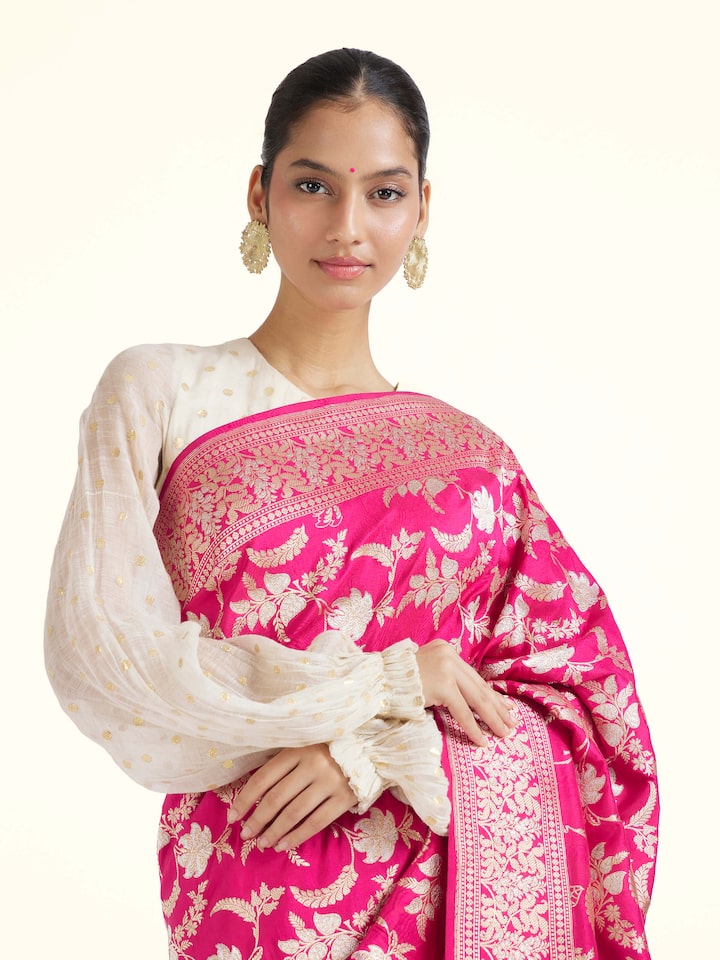 Angled view of pink silk Banarasi saree highlighting classic Banarasi weave and sheen