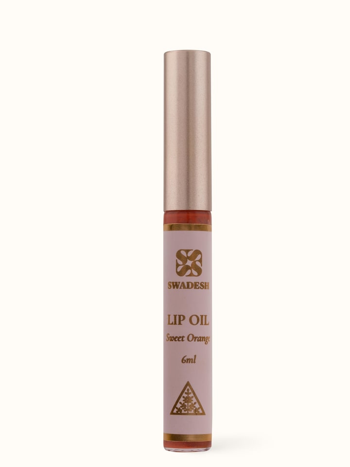 Front view of Lip Oil Sweet Orange showcasing the sleek packaging and vibrant orange hue