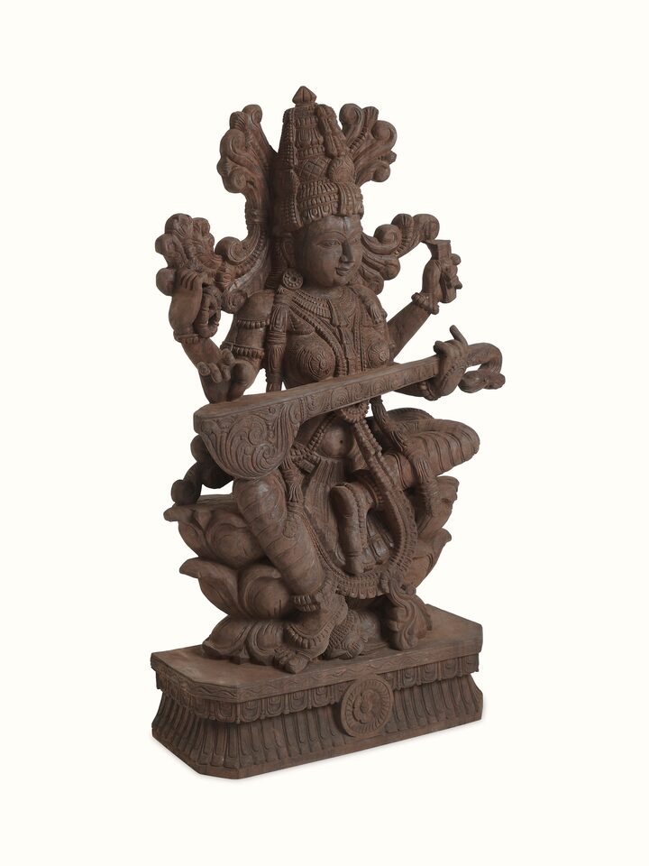 Angled view of the Wood Carved Sitting Saraswati Idol