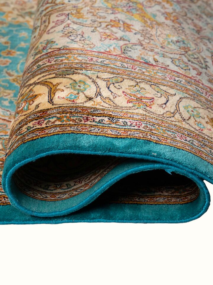 Detail view of Traditional Persian Blue Tabriz Kashmir Silk Hand-Knotted Carpet highlighting the intricate pattern and pile texture, from a differe...