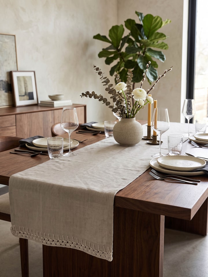 Styled view of Nityam Beige Cotton Slub Crochet Table Runner styled on a table or bed setting