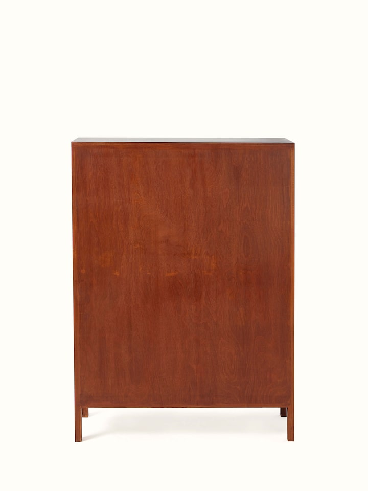 Angled view of teak wood and cane bar cabinet, showing the cabinet’s detailed cane work and rich wood texture.