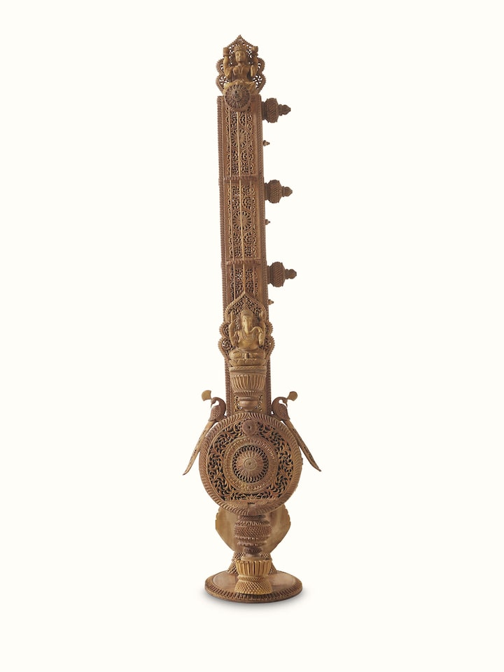 Front view of carved sandalwood veena sculpture, showcasing the fine craftsmanship and traditional artistry.