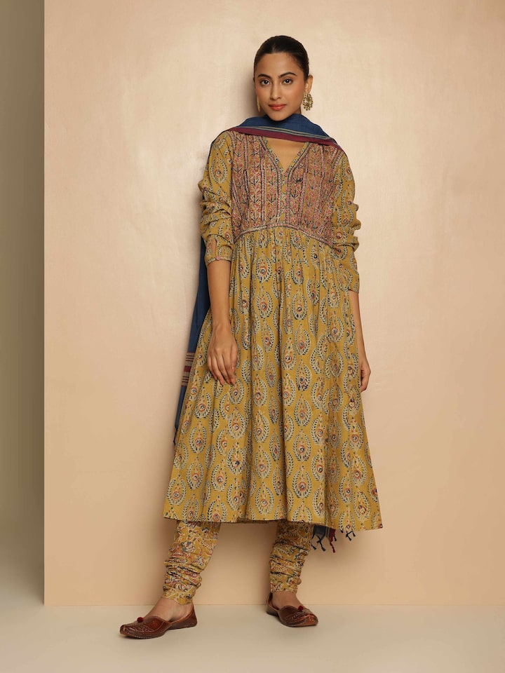 Lifestyle view of Yellow Cotton Kalamkari Block Printed Churidaar worn to show comfortable fit and traditional design.