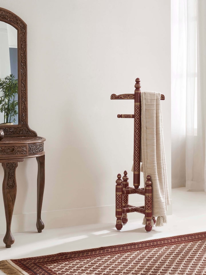 Side view of Teak wood Sankheda maroon coat hanger highlighting its detailed craftsmanship, vibrant maroon color, and traditional design.