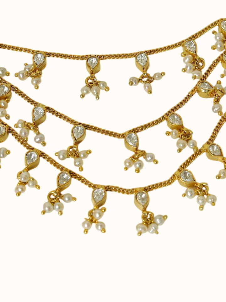 detail view of silver smithing gold plated ear chain chainwork
